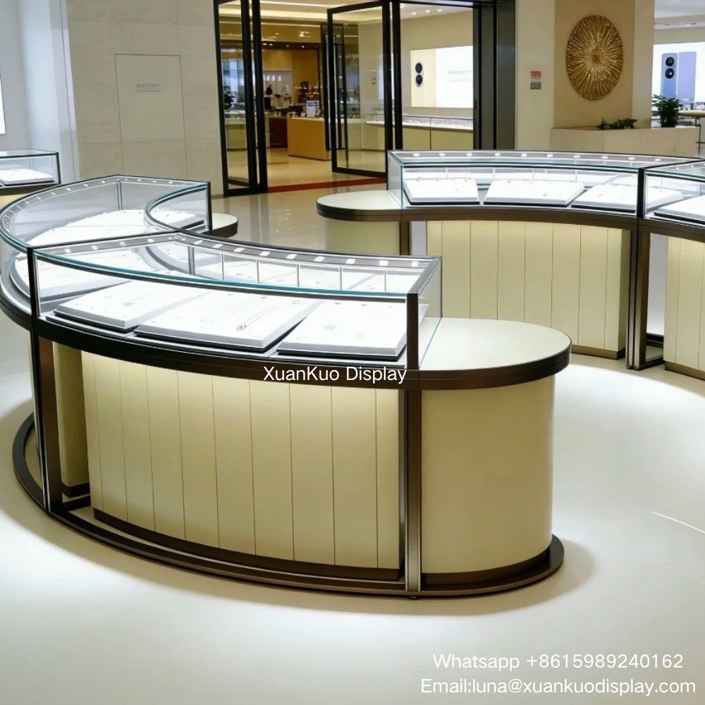 luxury curved jewelry display showcase, ultra clear tempered curved glass, beige vertical leather wrapped cabinet base, dark gunmetal metal frame, built-in LED spotlights, lockable glass display island for ring, necklace and diamond jewellery boutique