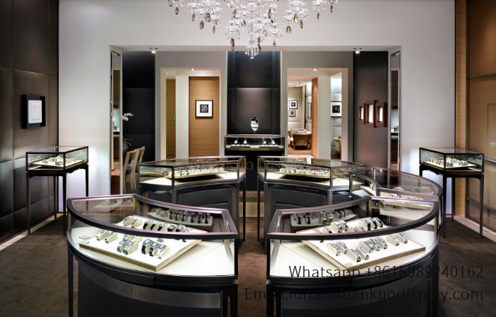 high end luxury jewelry store design curved glass display counters tall pedestal showcases crystal chandelier decoration