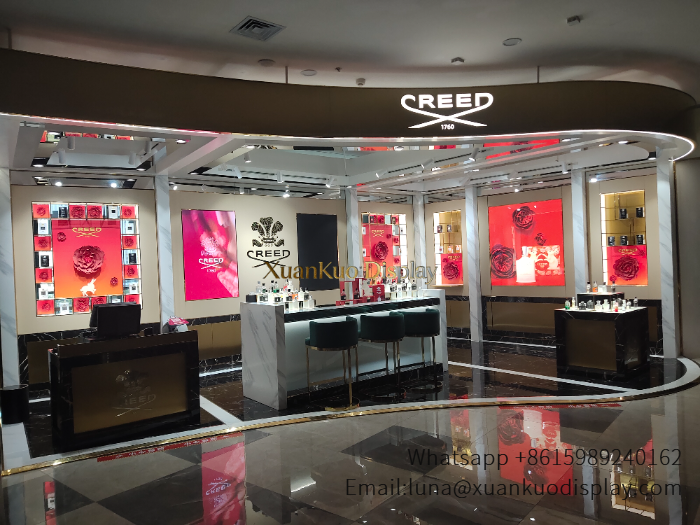 cream gold curved luxury fragrance display marble central consultation counter grid wall showcase brand backlit logo mall perfume kiosk