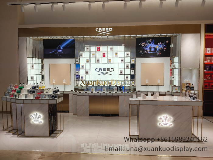 jewellery shop interior design Vietnam luxury marble gold frame perfume wall display grid compartment showcase with dual digital screens brand backlit logo