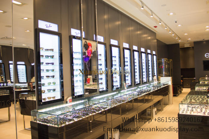 luxury multi brand eyewear display wall furniture dark wood optical boutique