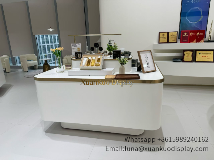 white gold trim curved skincare central display island beauty retail counter